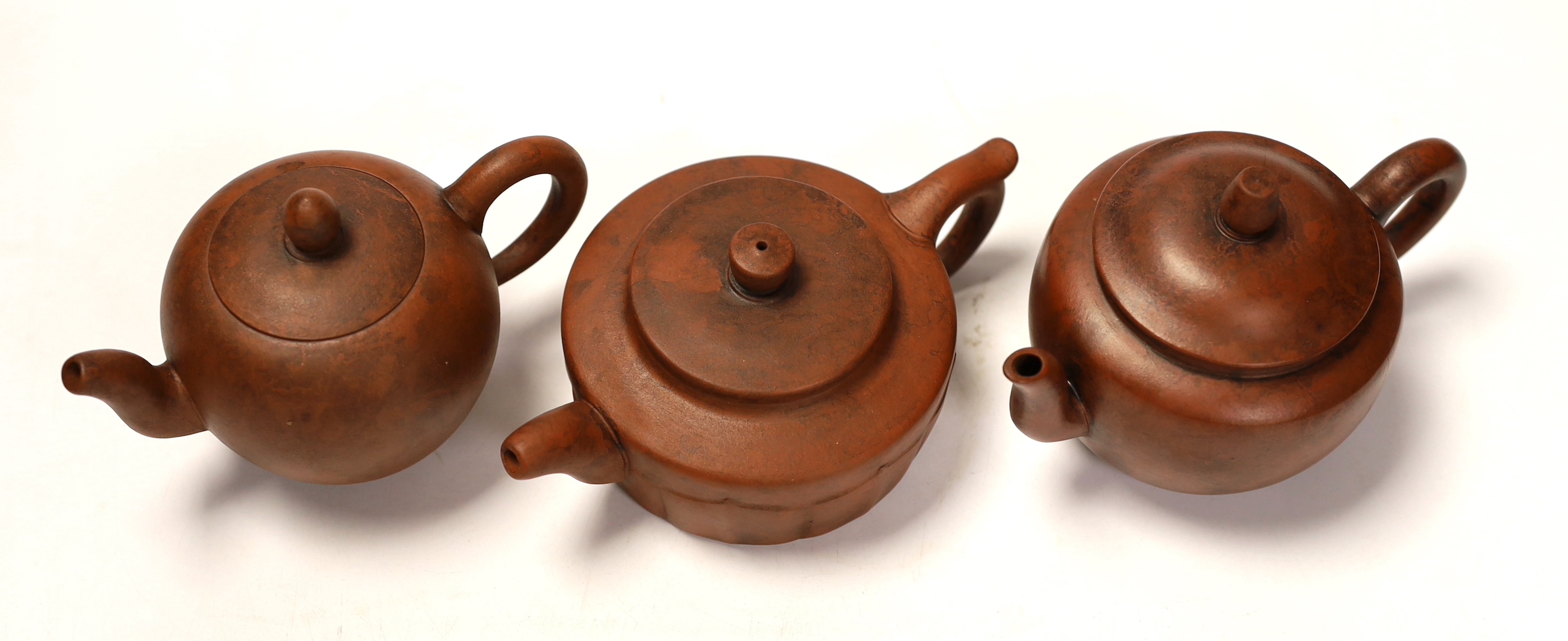 Three Chinese Yixing terracotta teapots, tallest 9cm